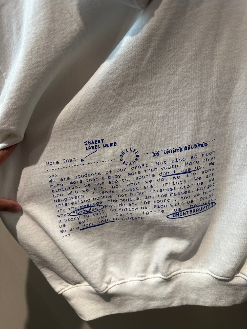 Uninterrupted Crewneck Sweatshirt with Blue Text on back